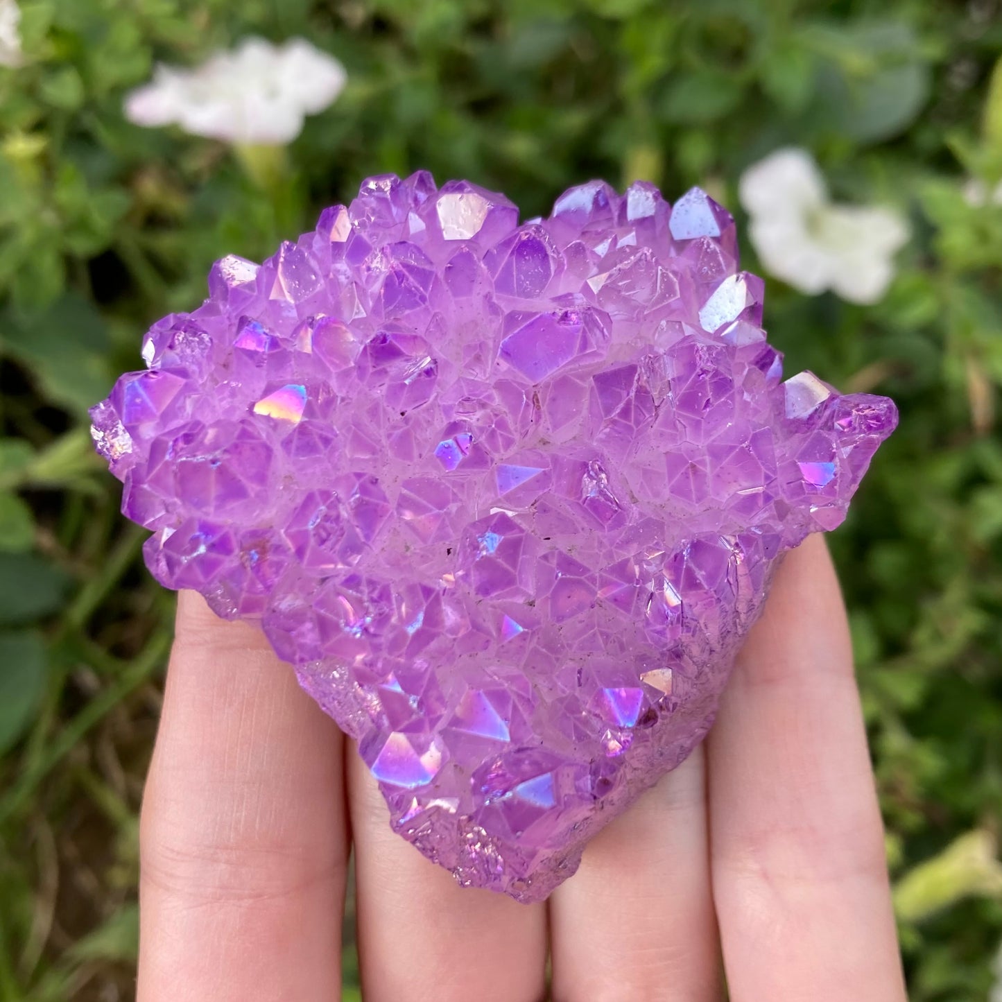 Lavender aura quartz crystal showing rainbow colours