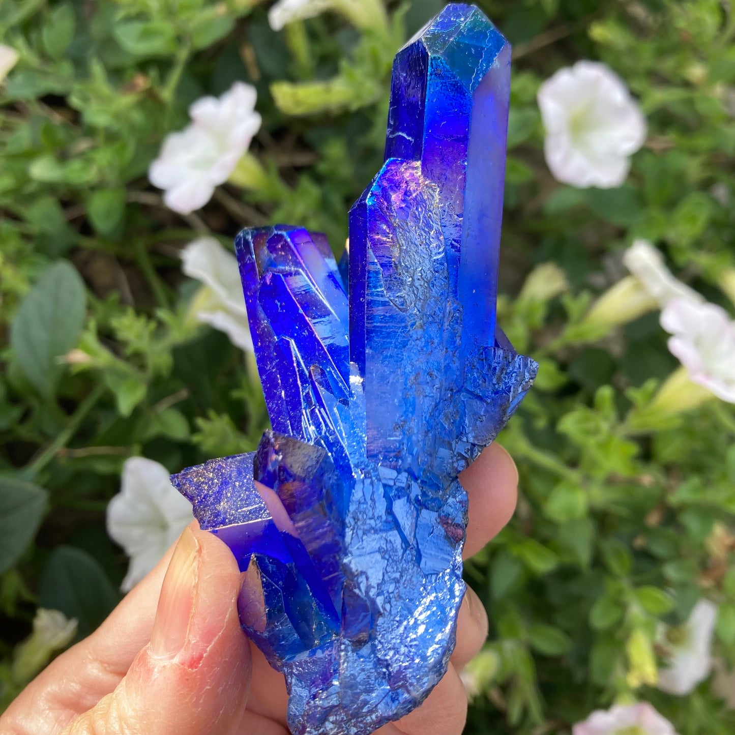 Side view of dark blue aura quartz crystal