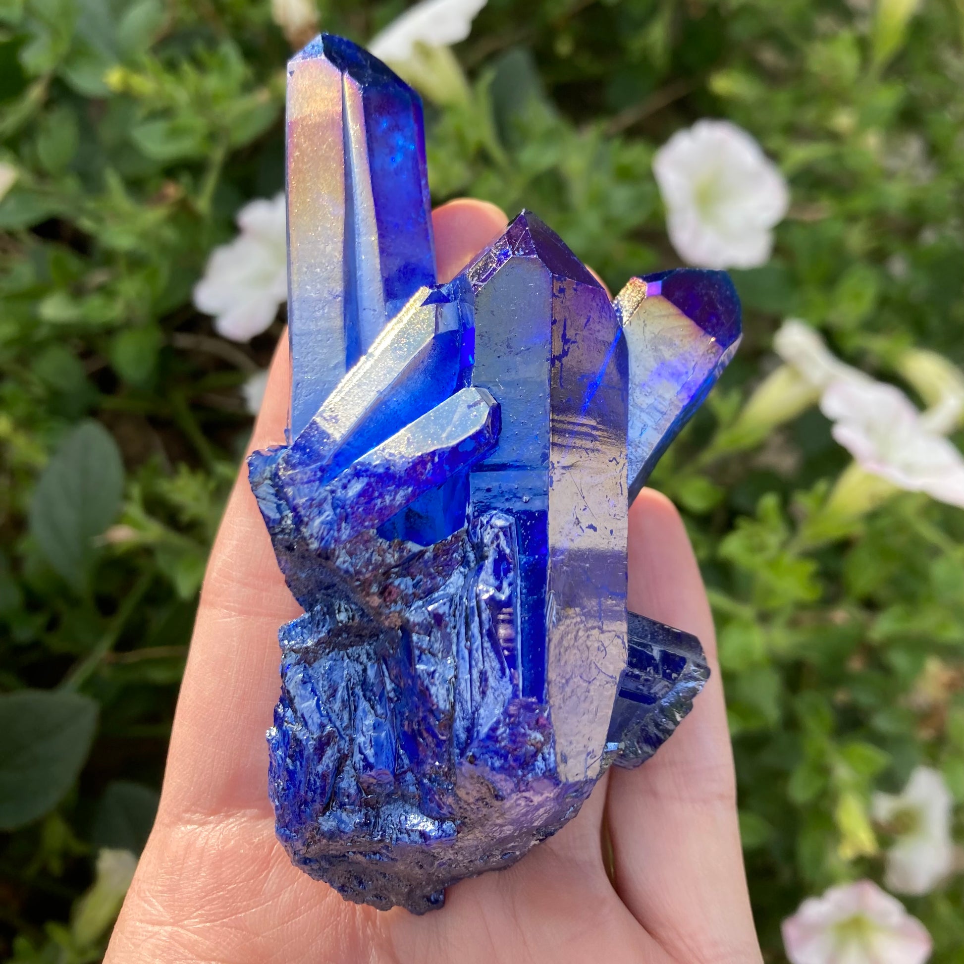 Cobalt aura quartz in palm of hand