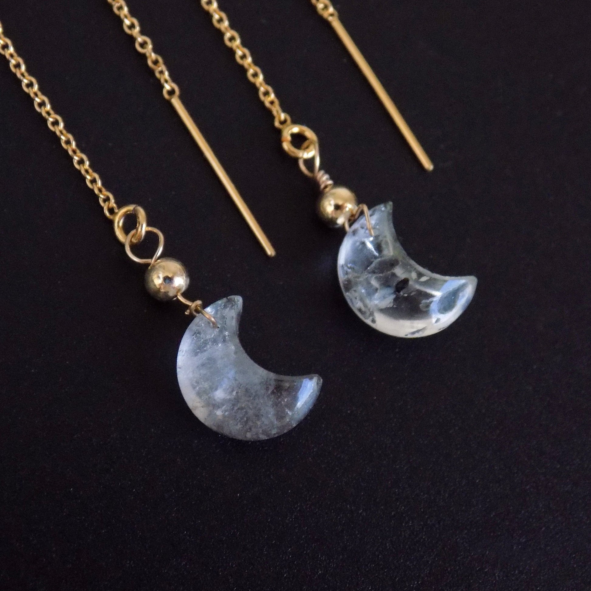 Close up of herkimer diamond moon earrings