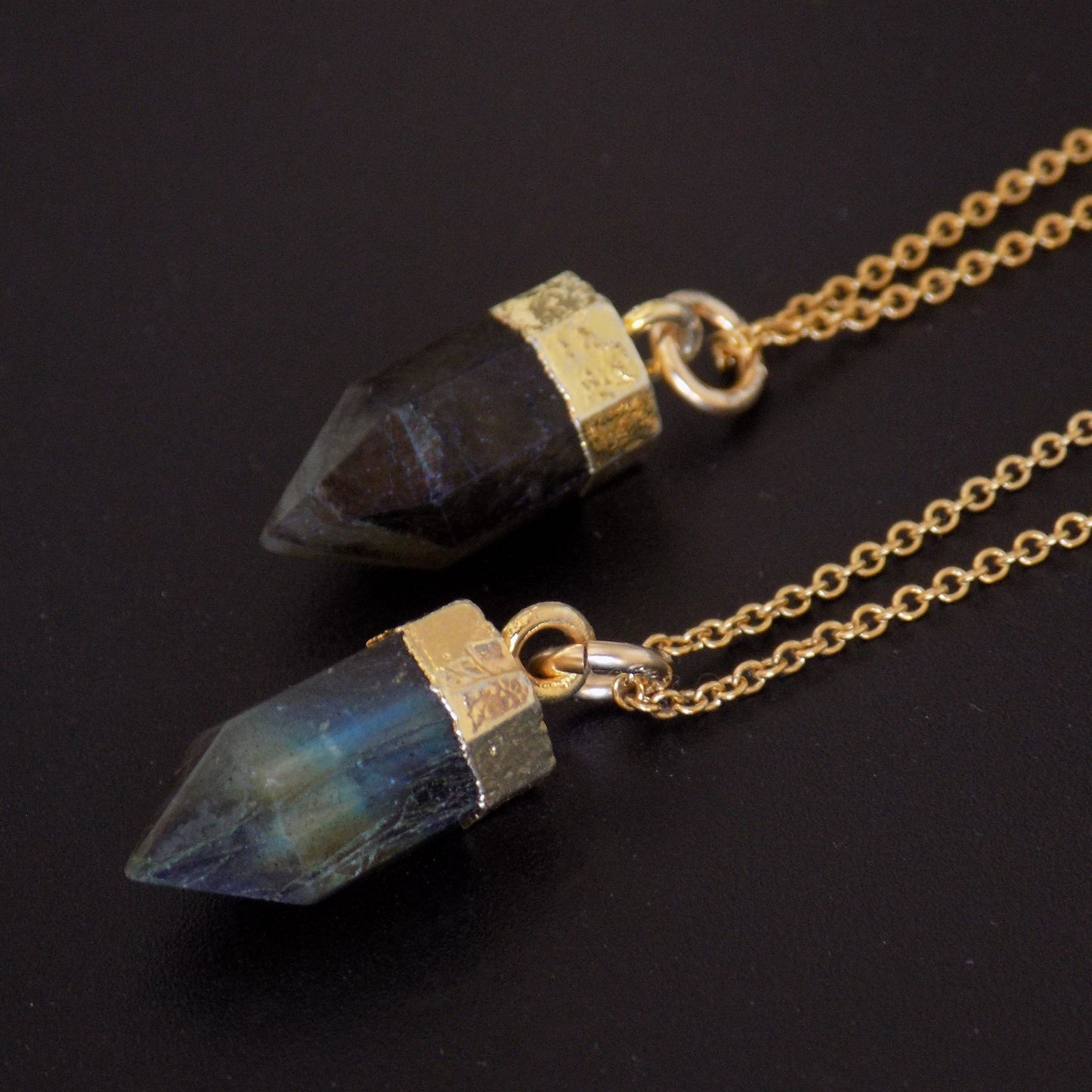 Close up of labradorite point pendants in 4K gold fill