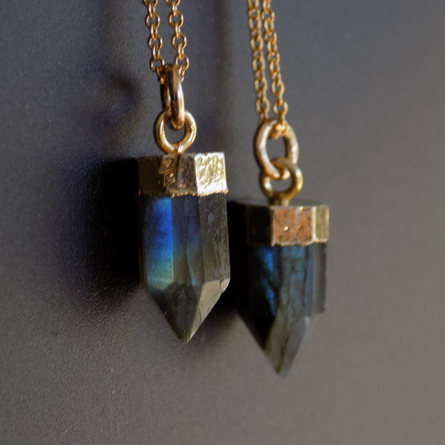 Flash labradorite point necklaces, on black background