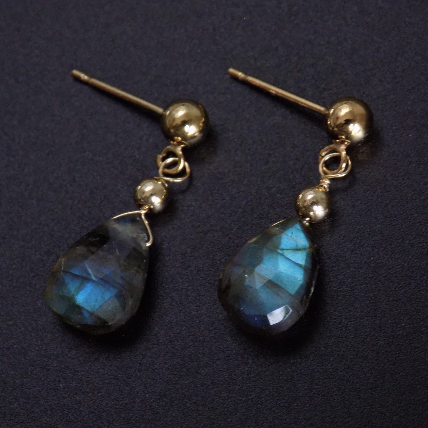 Labradorite dangly earrings on lack background