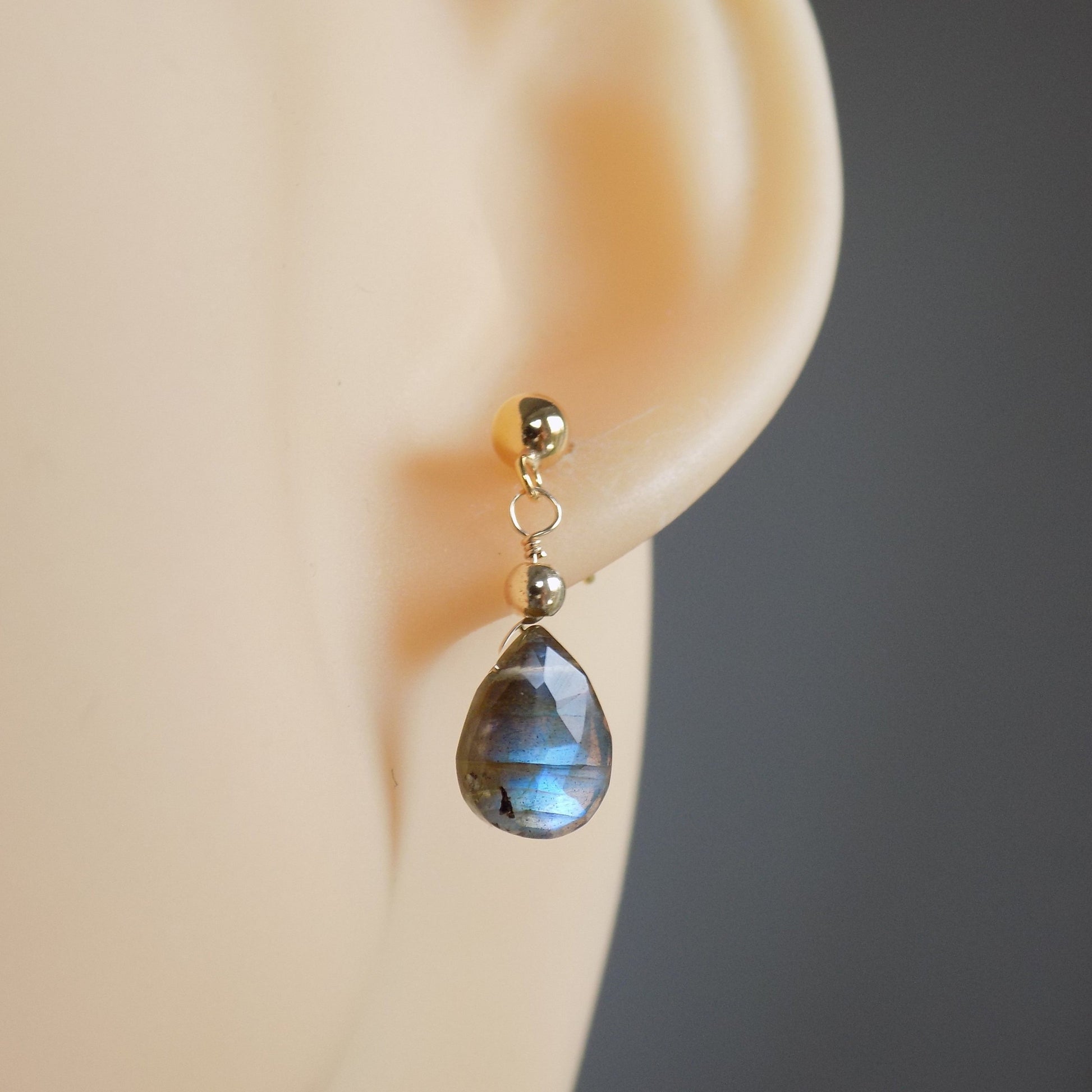 Flashy labradorite earrings on model