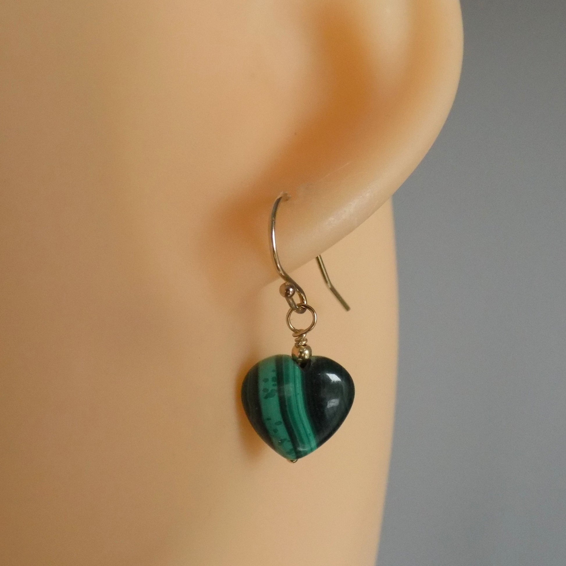 Malachite heart dangly earrings on model