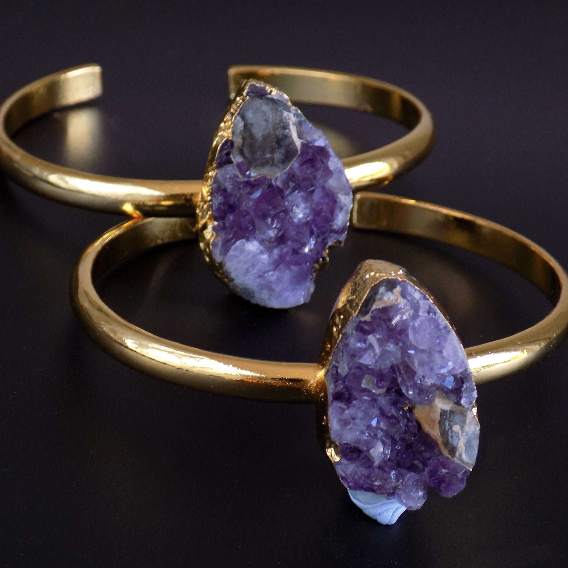 Stacked raw stone bangles, on black background