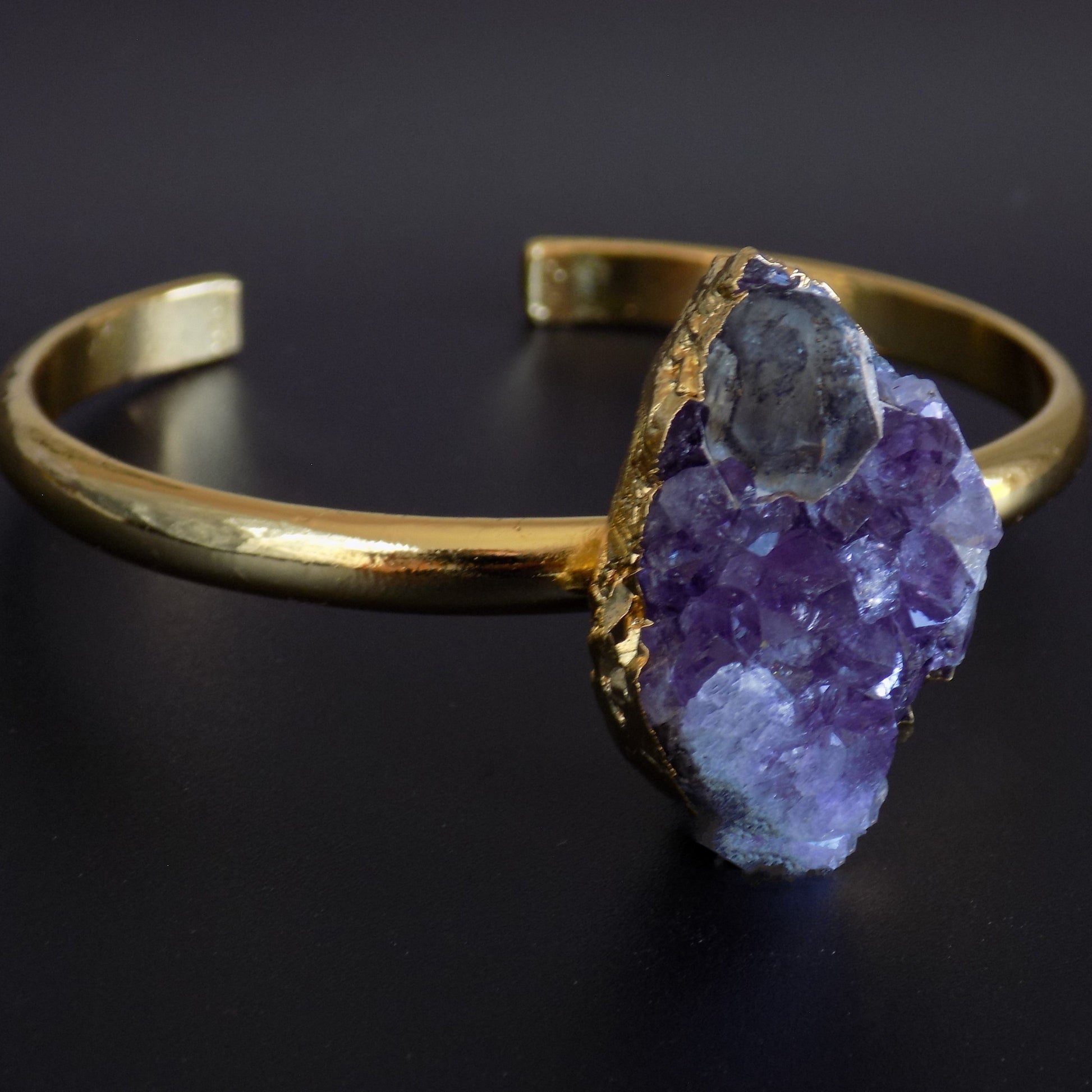 Close up of raw amethyst bracelet bangle in gold