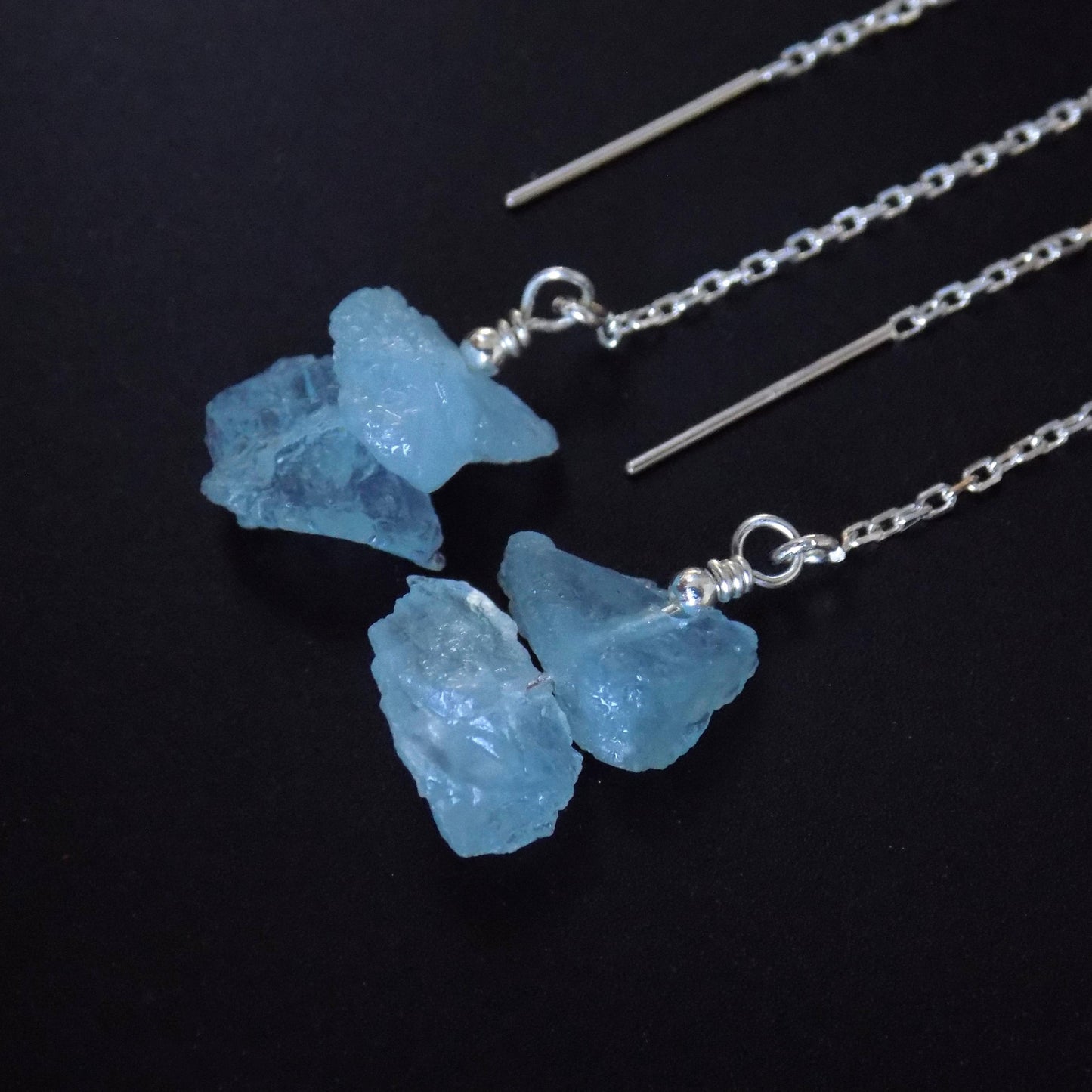 Close up of rough aquamarine gemstone chain earrings