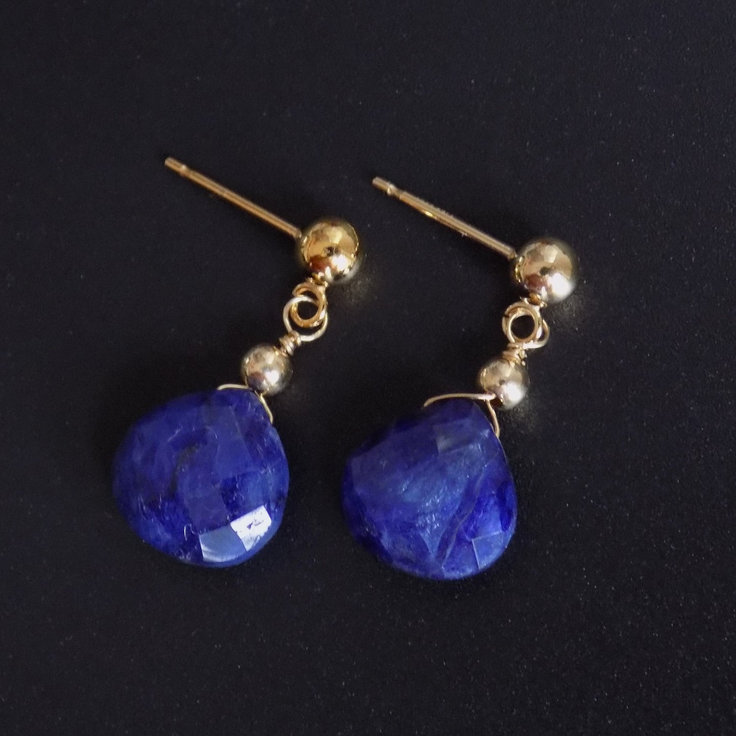 Close up of faceted sapphire dangly earrings