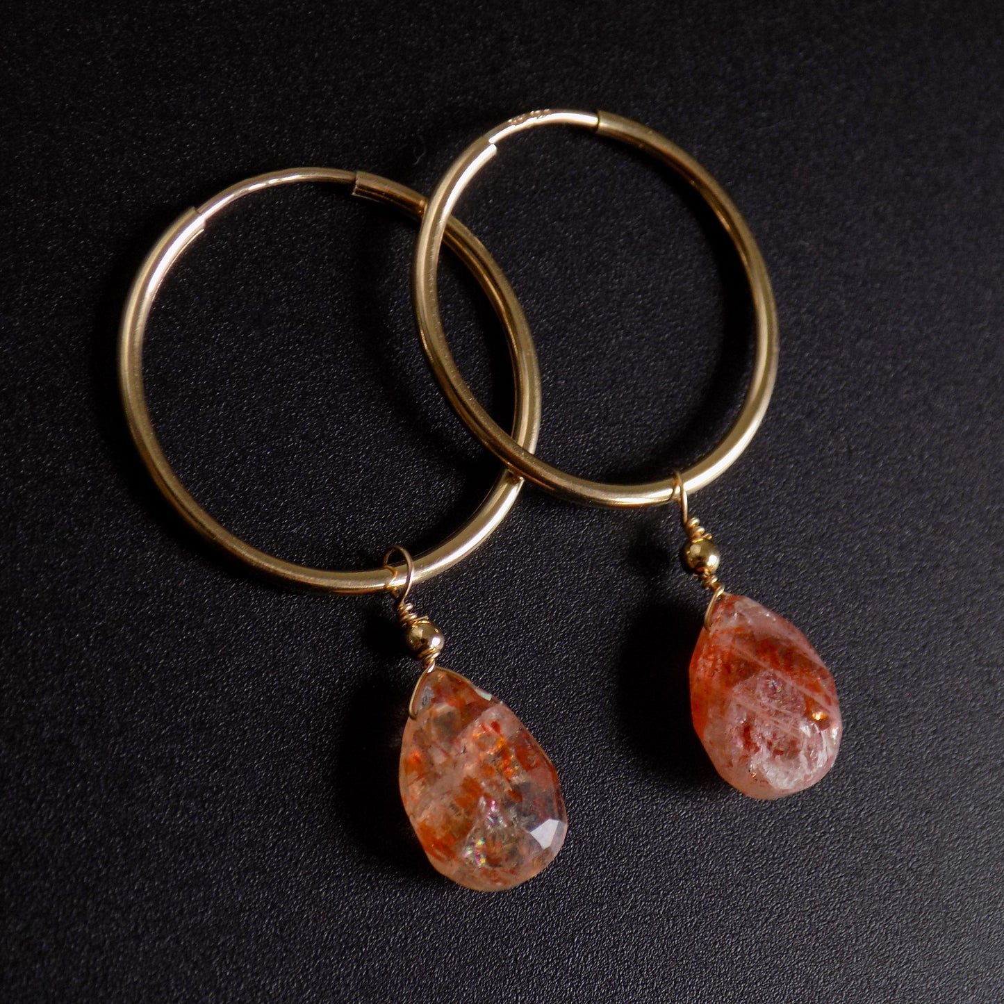 Sunstone teardrop hoops on black background