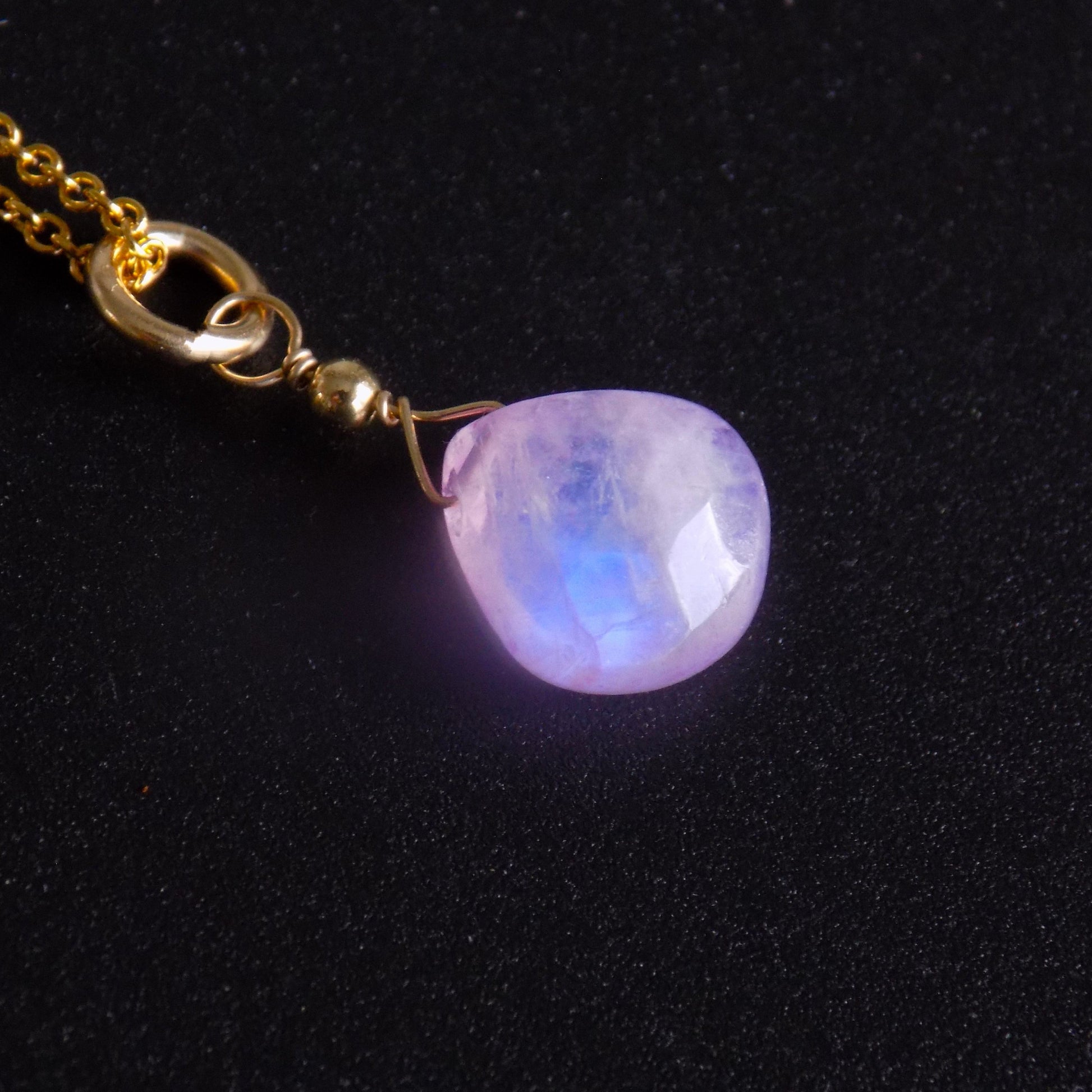 Close up of lilac moonstone pendant with blue flash